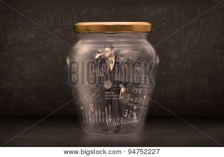 Businessman traped in jar with graph chart symbols concept on background