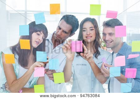 Young creative business people looking at the photo editor at office
