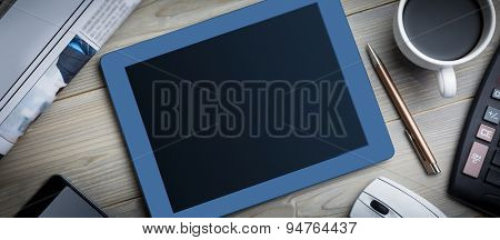 Tablet next to the smartphone cup of coffe and keyborad at the office