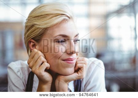 Selfassured female cook smiling in front of her bakery