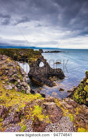 Magical coastal cliffs fishing village Arnastapi. July day in Iceland