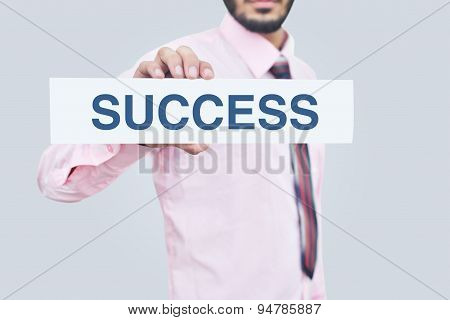 Holding a success note