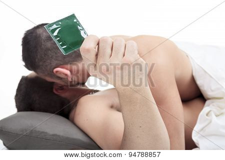 A homosexual couple onder a bed in studio white