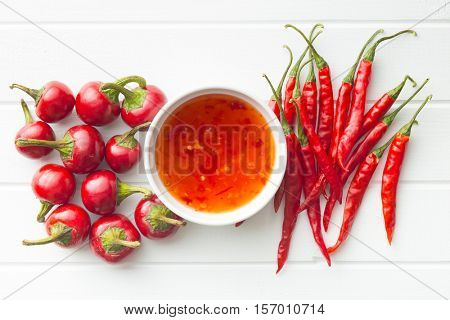 Red chili peppers and chili sauce. Top view.