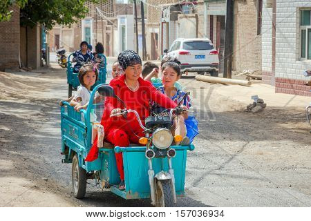 Woman Driving Kids In Motorbike Caravan