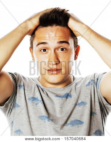 Young attractive handsome man holding hands on his head emotional wondering isolated on white background