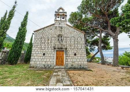 Virgin Mary church on graveyard in Tucepi, Croatia.