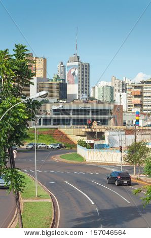 Campo Grande MS Brazil - November 10 2016: Landscape of the city of Campo Grande. City with some buildings between trees car traffic and urban art.