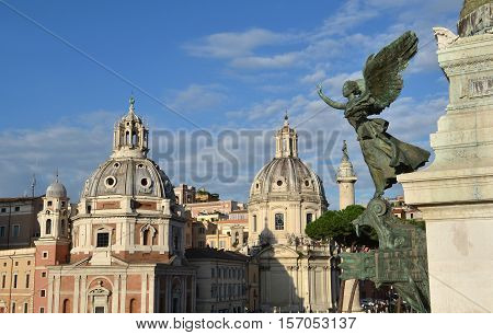 View of the Trajan's Forum twin churches dedicated to Virgin Mary from Vittoriano monument with renaissance and baroque domes in front of ancient victory column