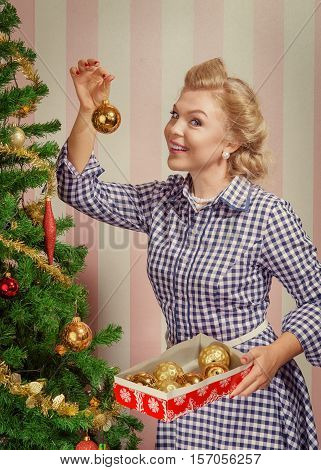 portrait of nice young woman hanging around christmas tree on x-mas  eve