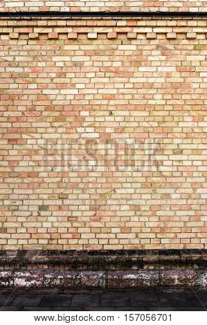 Yellow brick wall background with stone basement