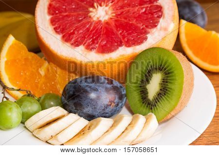 Different fruit for diet on a white plate