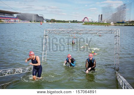 MOSCOW, RUSSIA - AUG 14, 2016: Participants of swimming stage of traditional 3Grom series triathlon contest in Krylatskoye Rowing Channel.