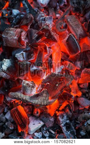 Burning coals. Decaying charcoal. Texture embers closeup. burning charcoal in the background
