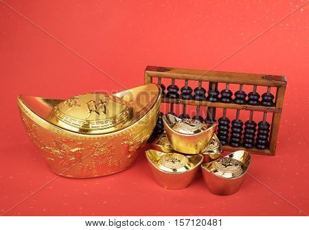 Chinese gold ingot and abacus mean symbols of wealth and prosperity.