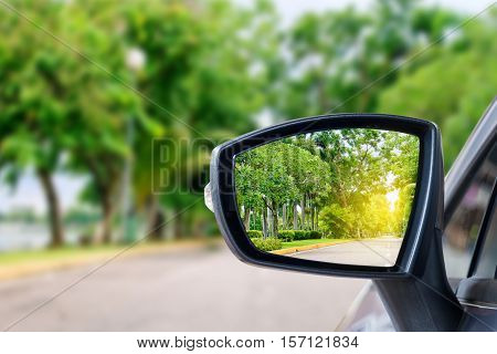 side rear-view mirror on a car on the road.