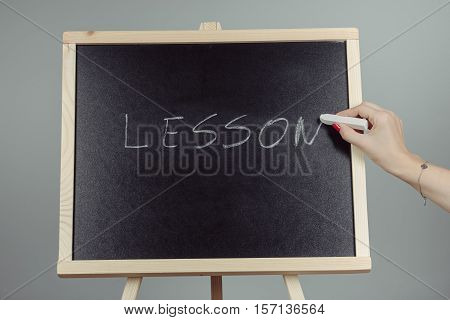 Lesson Written In White Chalk On A Black Chalkboard