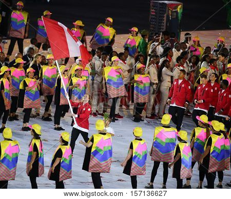 RIO DE JANEIRO, BRAZIL - AUGUST 5, 2016:Olympic champion trampoline gymnast Rosie MacLennan carrying Canadian flag leading the Olympic team Canada in the Rio 2016 Opening Ceremony at Maracana Stadium
