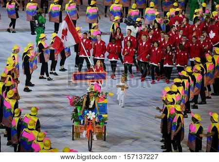 RIO DE JANEIRO, BRAZIL - AUGUST 5, 2016:Olympic champion trampoline gymnast Rosie MacLennan carrying Canadian flag leading the Olympic team Canada in the Rio 2016 Opening Ceremony at Maracana Stadium