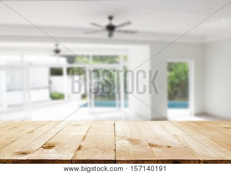 table top and Blurred abstract background interior view looking out toward to empty office lobby and entrance doors and glass curtain wall with frame: Blurry perspective of reception hall to building entry/ exit