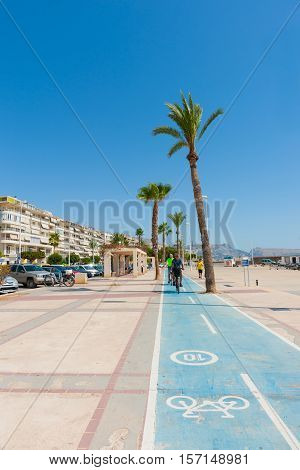 Altea, Spain - September 7, 2016; Cyclists on esplanade cycle-way along waterfront in Altea Spain.