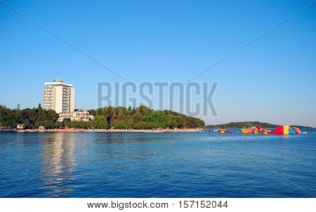 Beach with pines in Vodice in the sunset Croatia.