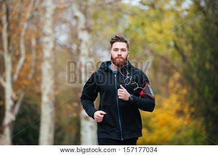 Front view of runner in park. looking at camera