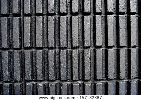 Black walls a vertical rectangular blocks arranged in a row.