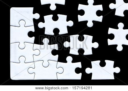 puzzle pieces coming together against a black background