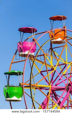 Ferris wheel cabin gondolas closeup three rotating pods for patrons enterainment