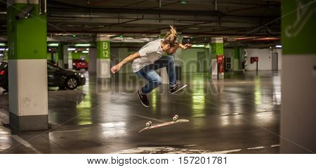 Skater Doing Tricks And Jumping In The Underground Garage