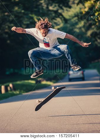Action Shot Of A Skateboarder Skating, Doing Tricks And Jumping