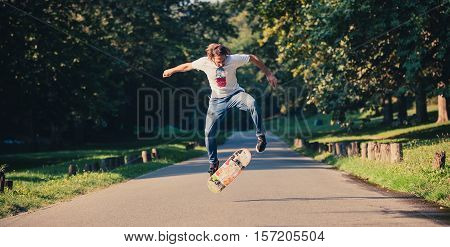 Action Shot Of A Skateboarder Skating, Doing Tricks And Jumping