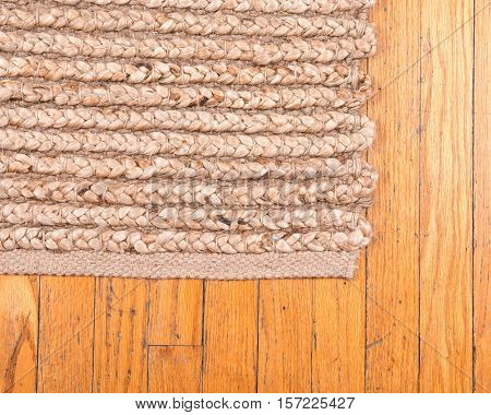 Jute pile hand woven beige area rug on old hardwood floor