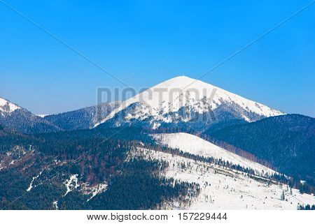 Snowy peak of Mount Hoverla at 2061 metres (6762 ft) - the highest mountain in Ukraine and part of the Carpathian Mountains a notable tourist attraction extreme sports site in the winter period.