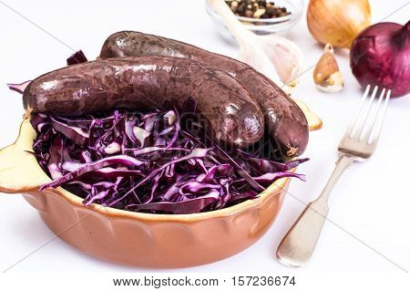 Homemade blood sausage with cabbage on a white background. Studio Photo