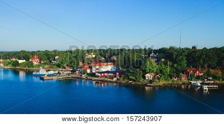 Beautiful super wide-angle aerial view of Stockholm archipelago skerries and suburbs with classic sweden scandinavian designed cottage houses from massive ferryboat