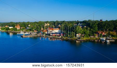 Beautiful super wide-angle aerial view of Stockholm archipelago skerries and suburbs with classic sweden scandinavian designed cottage houses from massive ferryboat