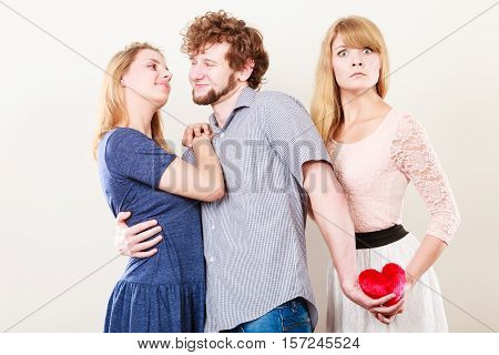 Jealousy and betrayal concept. Abandoned unloved girl watching on happy hugging couple. Triangle relationship.