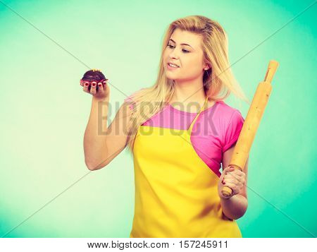 Woman Holding Rolling Pin And Chocolate Cupcake