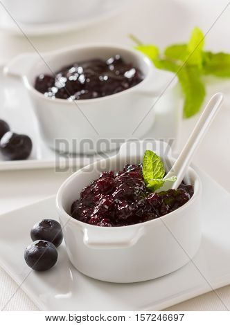 Homemade blueberry jam on a breakfast table.