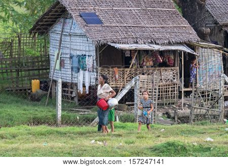 Sittwe - October 25 2016: Traditional housing with straw roof at the outskirts of Sittwe the capital of the Rakhine State in Myanmar a state with little development but with endless ethnic and religious conflicts.