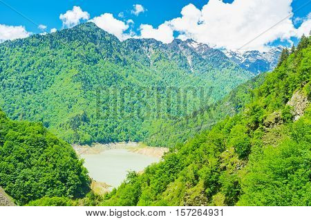 The mountain slopes covered with lush trees hide Patara Enguri River twisting in valley Upper Svaneti Georgia.