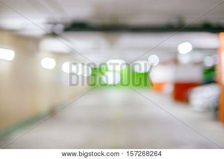 Blurred image Parking garage - interior shot of multi-story car park underground parking with cars.