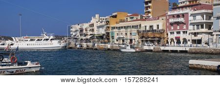 the promenade of Agios Nikolaos overlooking the sea and houses in Crete