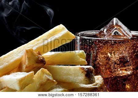 Cola with the ice in a glass and deep-fried potatoes