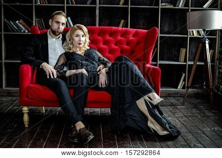 Sexy and beautiful young couple posing in studio
Beautiful blonde Woman with Luxury Makeup, Red sexy lips