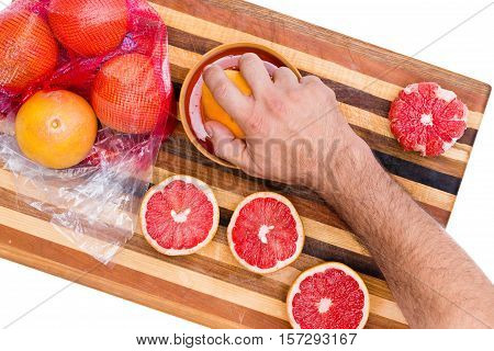 Man Squeezing Store Bought Fresh Ruby Grapefruits