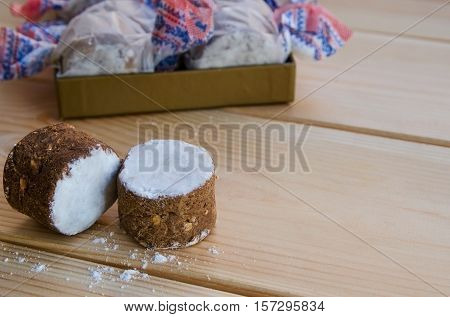 Close up of homemade polvoron typical sweets consumed in Spain at Christmas. Spanish shortbread on wood background.