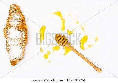 Honey dipper and fragrant honey into a bowl. Studio Photo